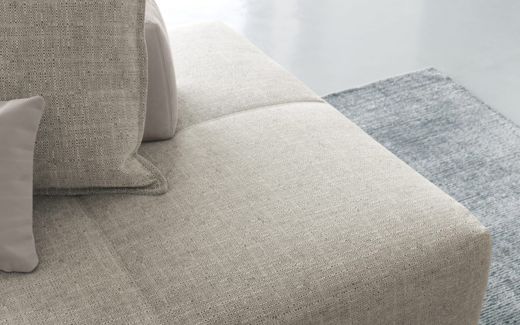 Closeup of Softbench one hundred fifty gray wide square modular sofa in a living room.