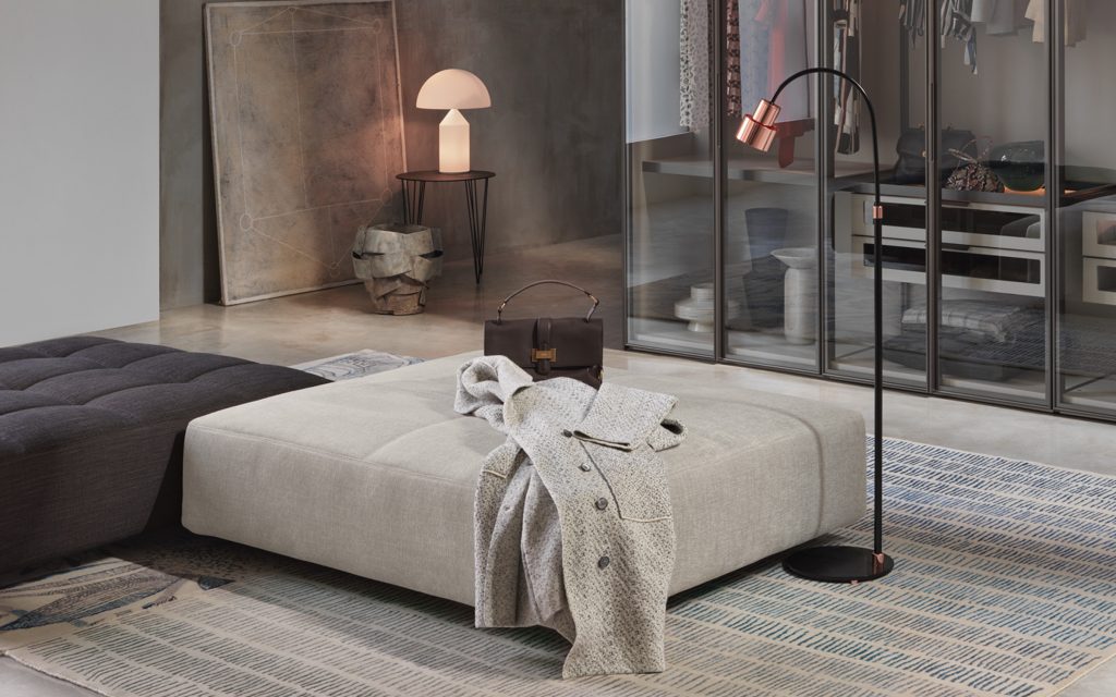 Two Softbench one hundred fifty two gray wide square modular sofas in a living room.