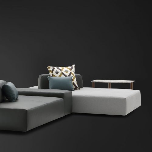 Two Softbench one hundred fifty three gray wide square modular sofas on a black background.