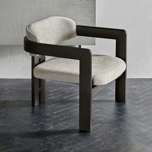 Angled view of Four Hundred Seventeen chair in white on a grey floor and white walled background