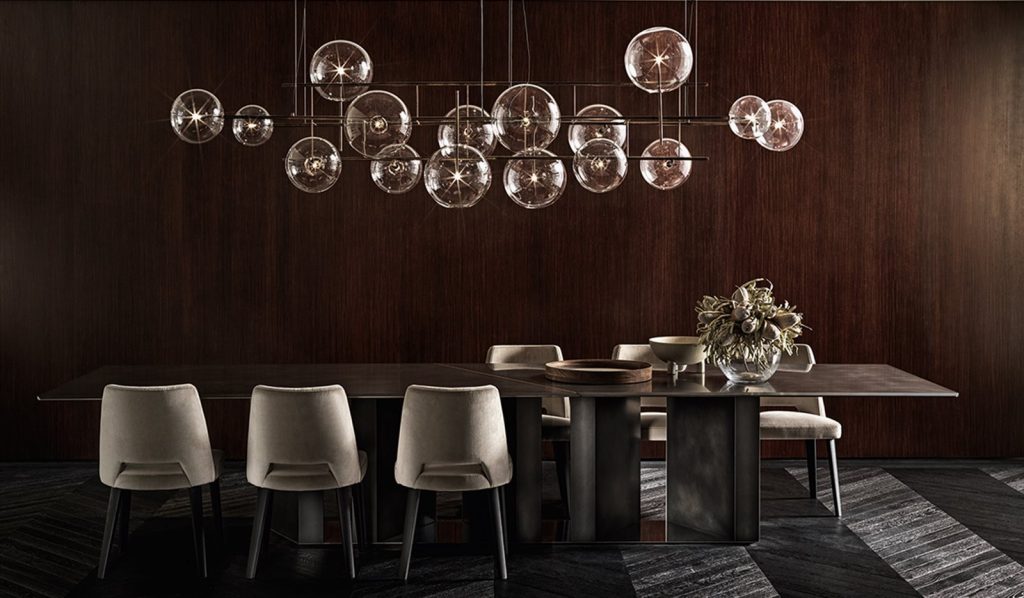 Large Platinium system table. Black rectangular shape with two legs in a dining room.