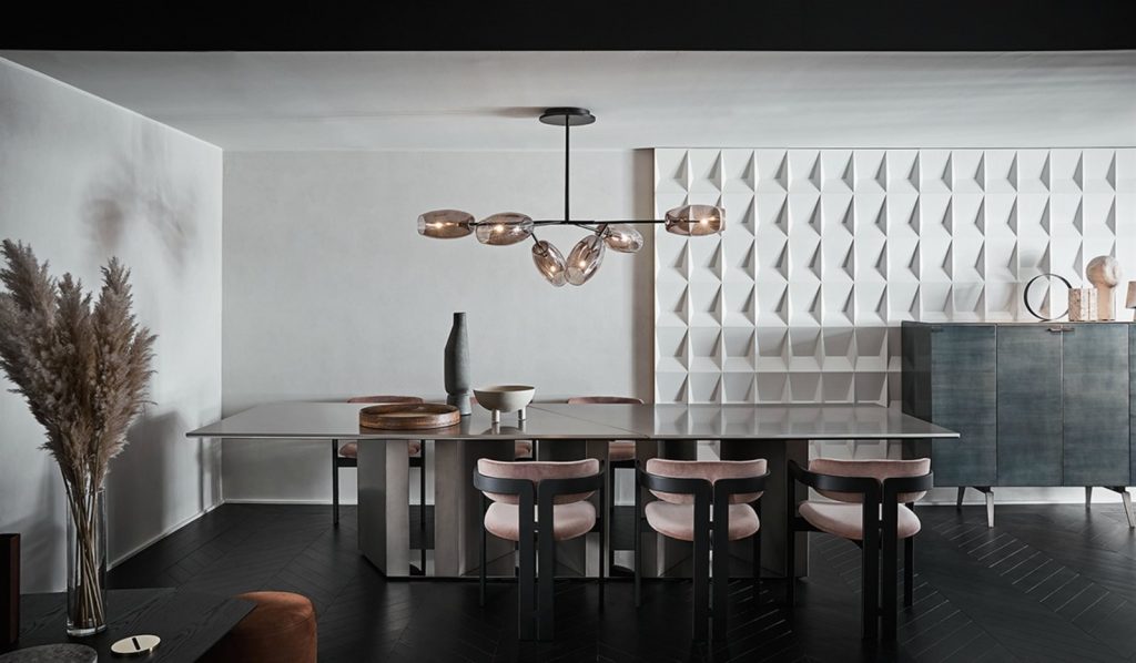 Large Platinium system table. Black rectangular shape with two legs in a dining room.