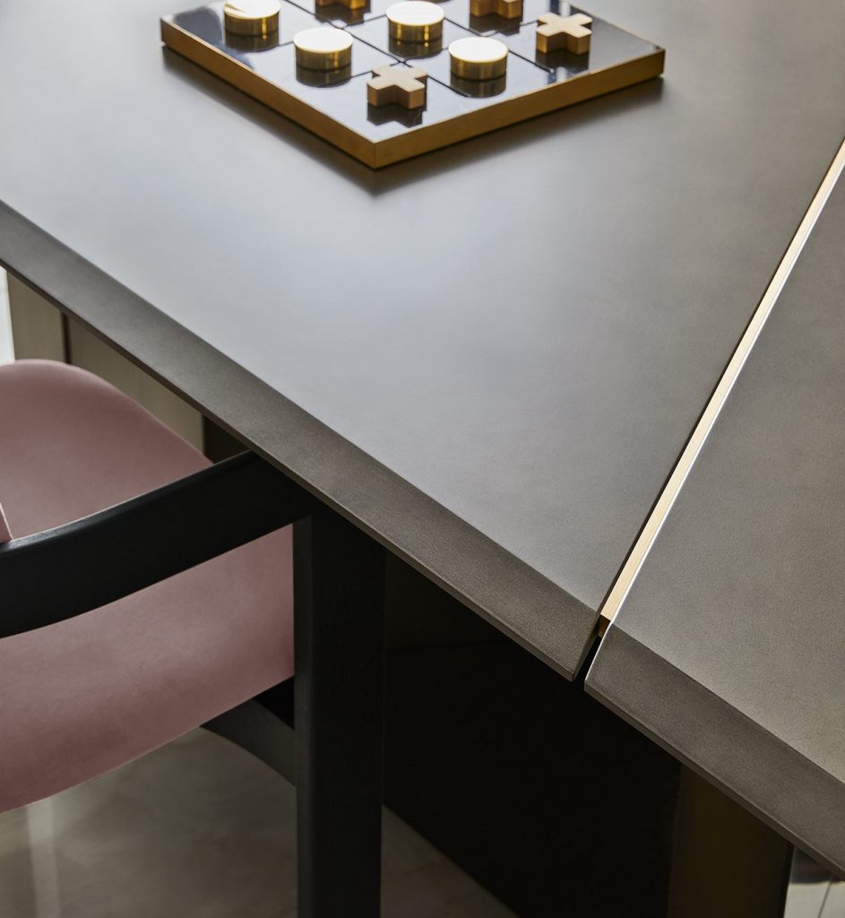 Closeup of Large Platinium system table. Black rectangular shape with two legs in a dining room.