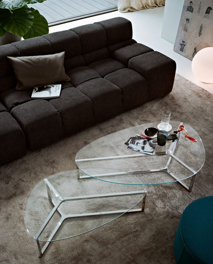 Raj 3: Two Oval glass coffee tables with a silver metal base in a living room.