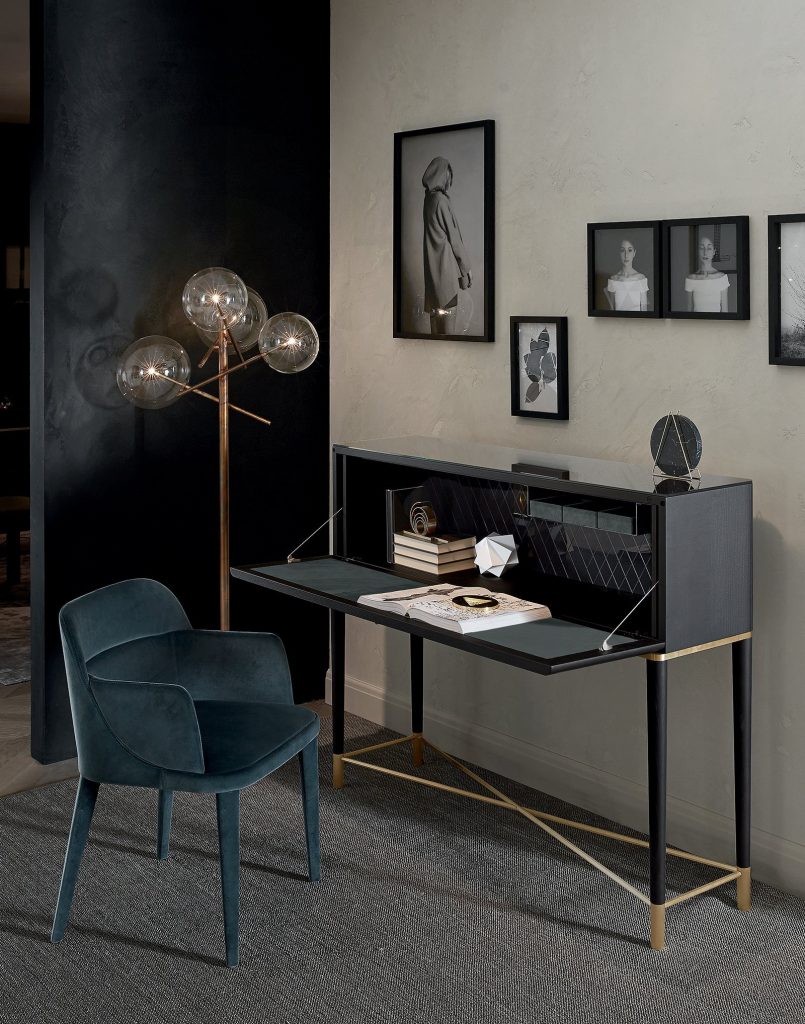 Tama Secrétaire: A wooden drawer with a fold-out desk in brown and gold in a living room.
