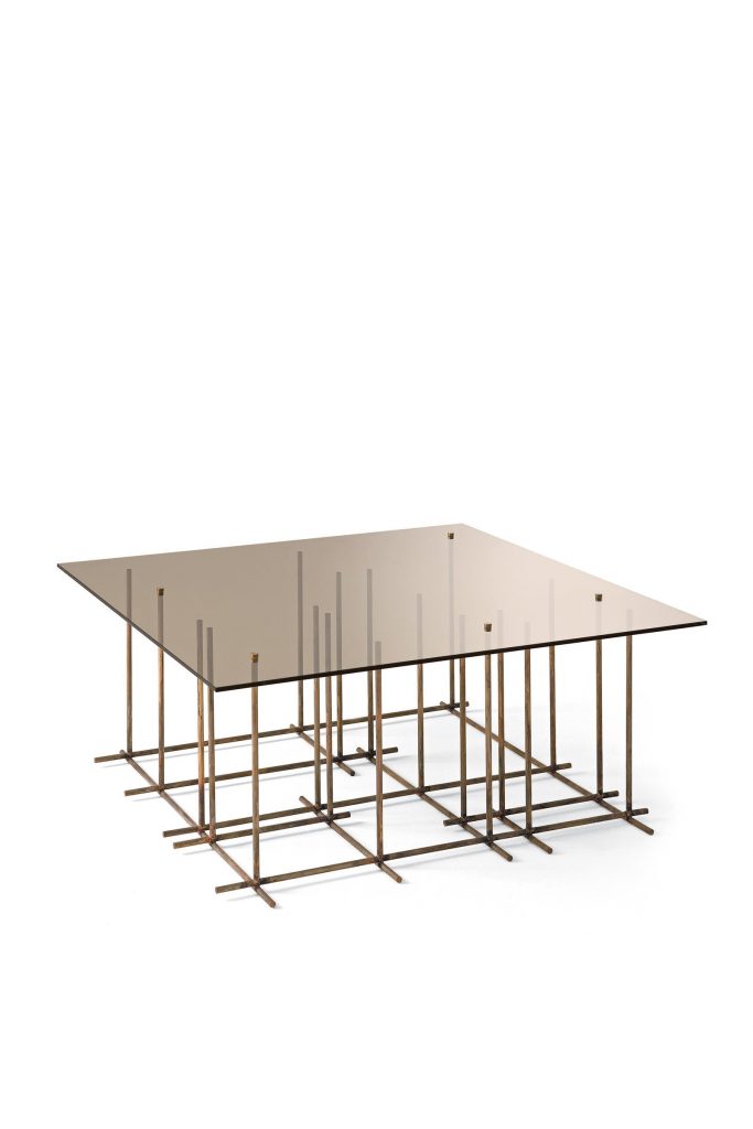 Tetris: A square glass-top coffee table with bronze metal frame and cubic shapes on a white background.