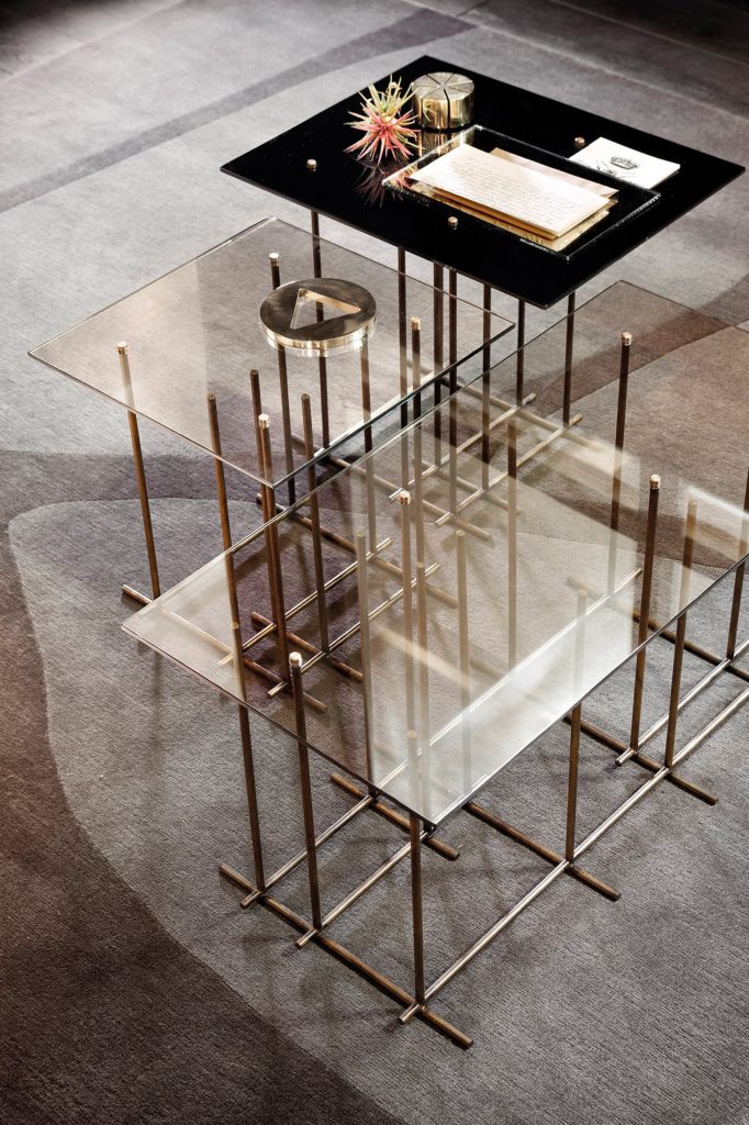 Tetris: Two rectangle glass-top coffee tables with bronze metal frame and cubic shapes in a living room.