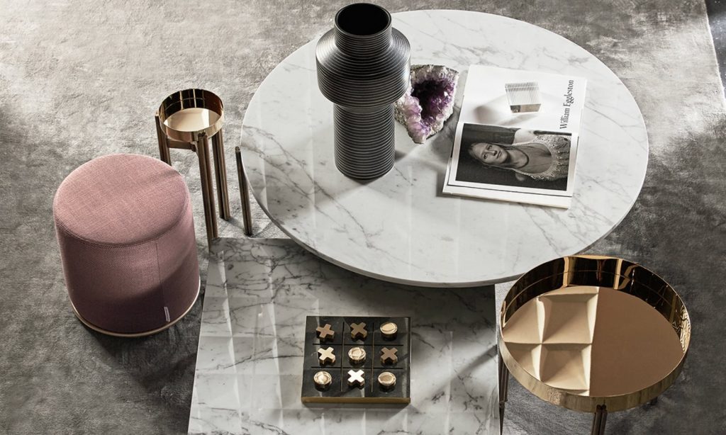 Tip Tap Toe square table game. Base in black and gold, pieces in gold in a living room.