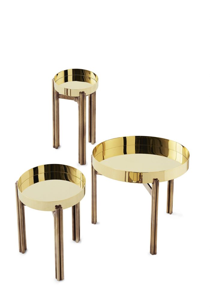 Three Twelve coffee tables with a golden round top and three bronze legs on a white background.