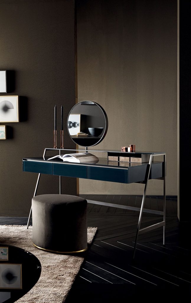 Venere wooden desk featuring a blue top and slender black legs in an office.