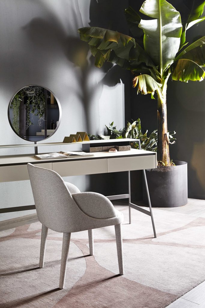 Venere wooden desk featuring a beige top and slender black legs in an office.