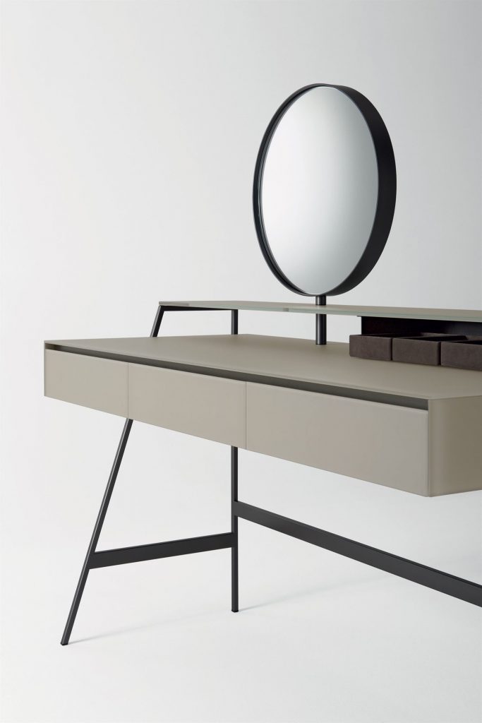Venere wooden desk featuring a beige top and slender black legs in an office.