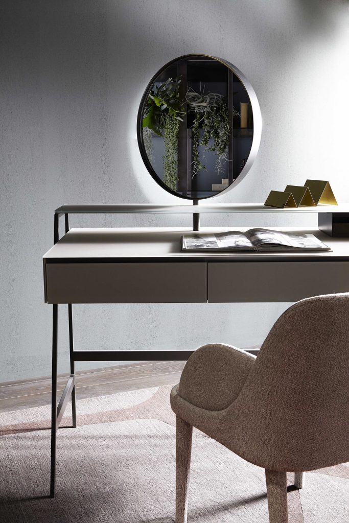Venere wooden desk featuring a beige top and slender black legs in an office.