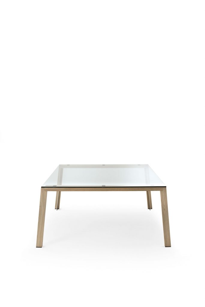 WGS table with crystal rectangle top eaturing wooden legs and a sleek metal frame on a white background.