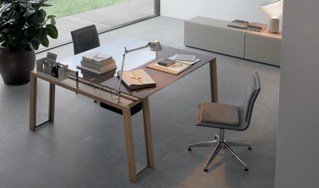 WGS table with crystal rectangle top eaturing wooden legs and a sleek metal frame in an office.
