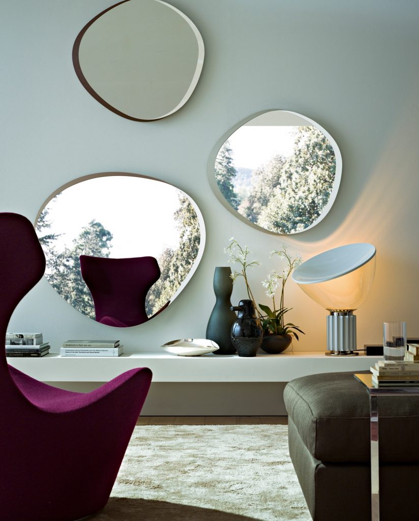 Zeiss Mirror with an elegant round shape and a thin metal frame in a living room.
