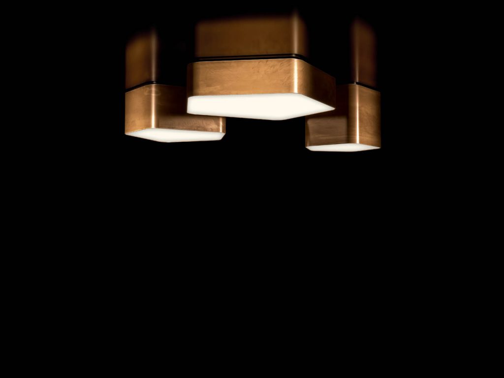 Bat Light LED ceiling lamp with pentagon shapes finished in brass on a black background.