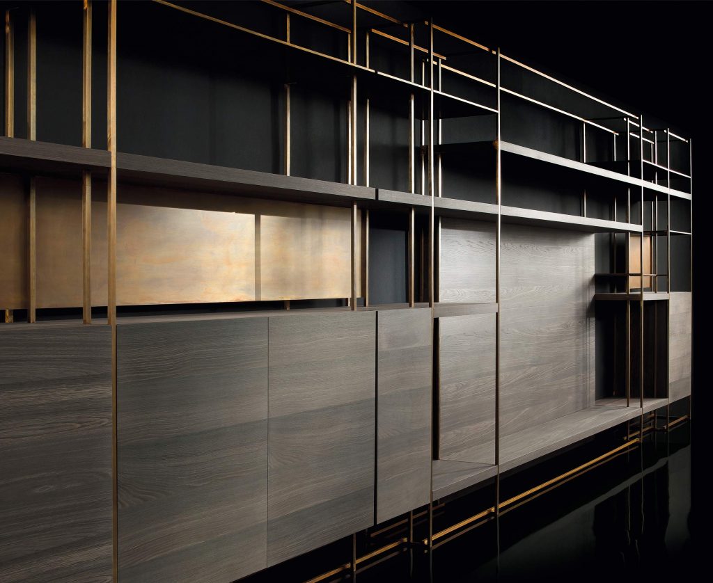 Cage C shelves with wood drawer and finish in brass on a black background.