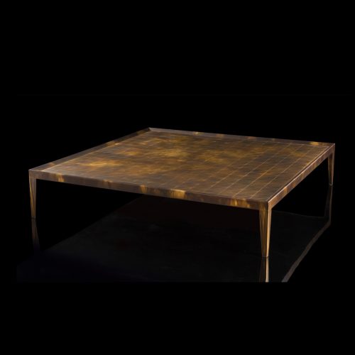 Square D Code Table top and four legs in brass on a black background.