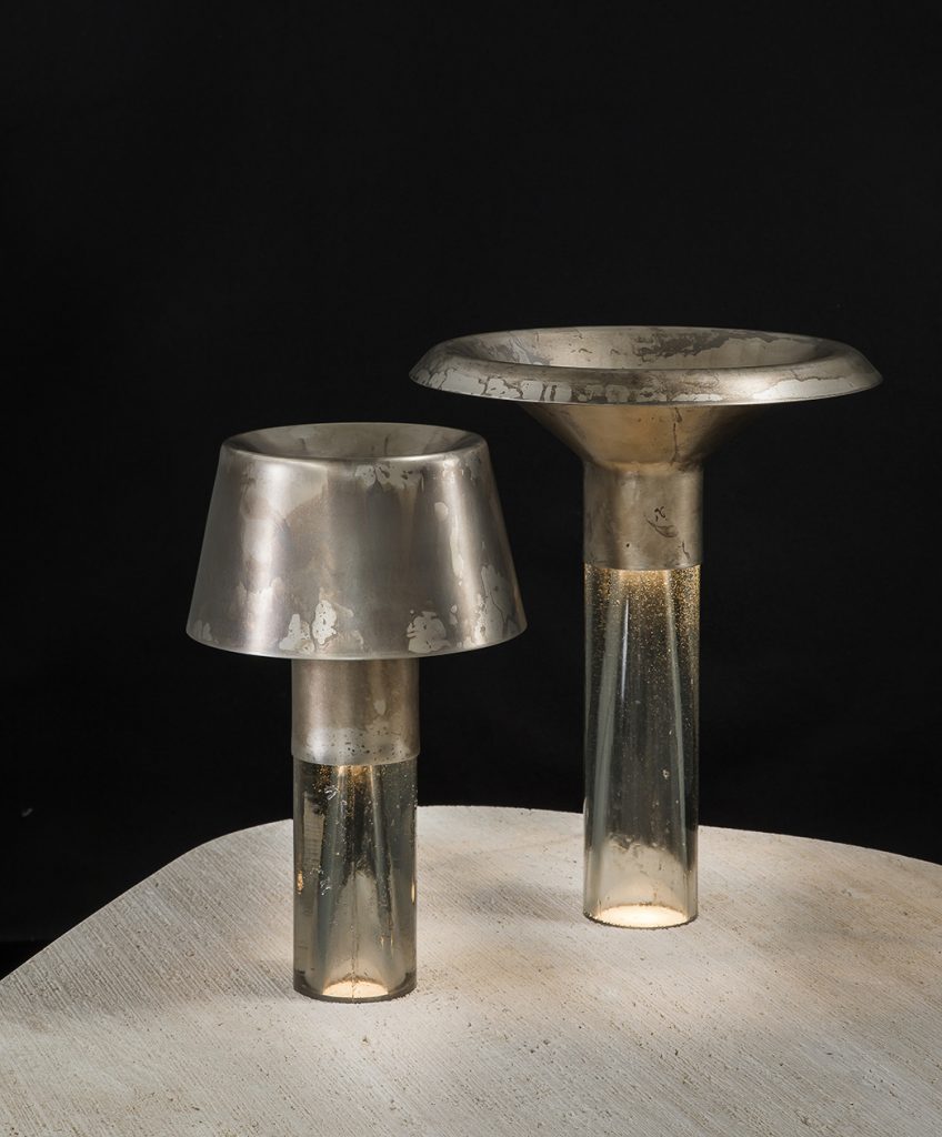 Two Ghost Lamp Tables, resin central element and steel light diffuser on black background.
