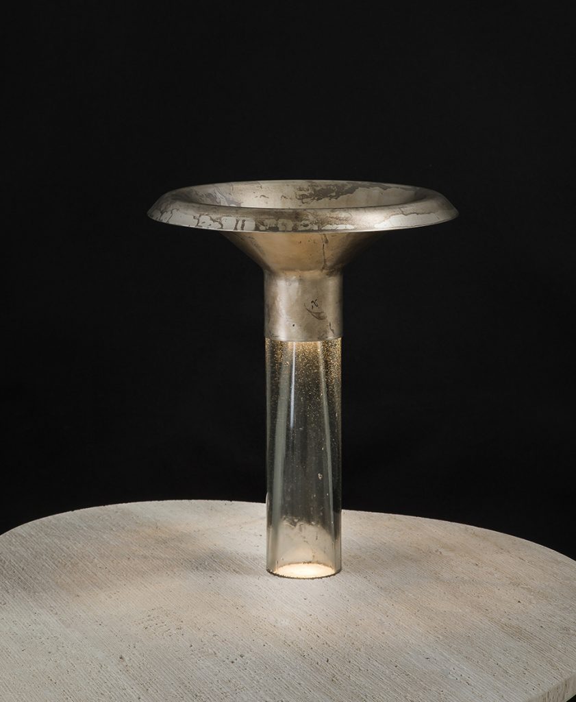 Ghost Lamp Table, central element in resin, light diffuser in steel on a table on a black background.