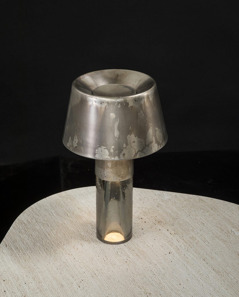 Ghost Lamp Table, central element in resin, light diffuser in steel on a table on a black background.