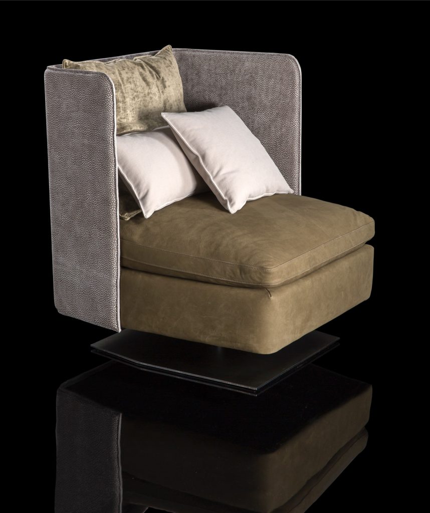 Human Armchair upholstered in brown leather and three gray cushions. Structure armchair with metal base frame and central leg on a black background.