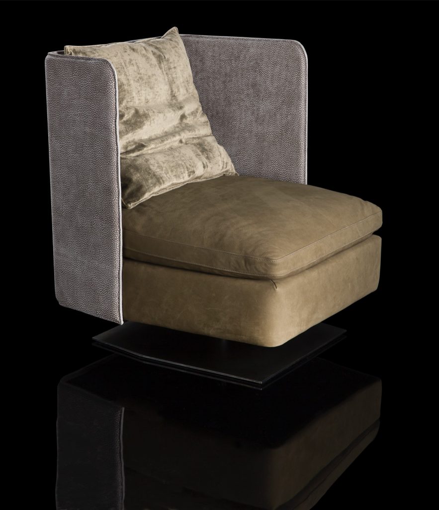 Human Armchair upholstered in brown leather and three gray cushions. Structure armchair with metal base frame and central leg on a black background.