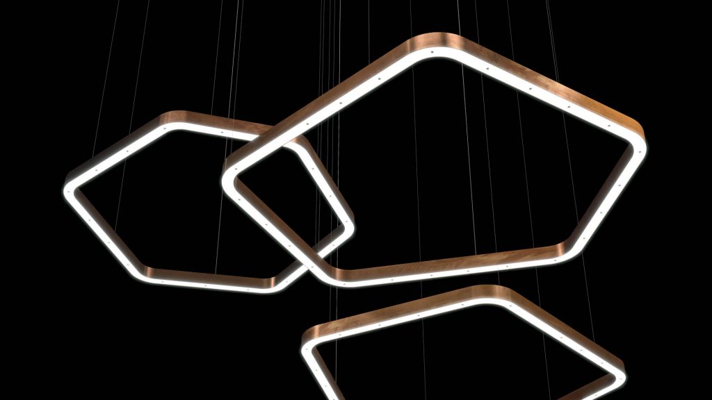 three polygon-shaped lamps made of metal in a golden color tone on a black background
