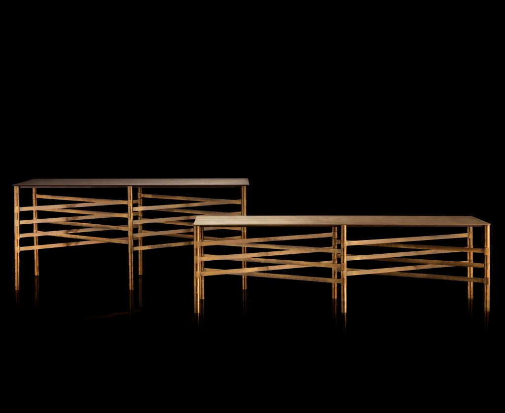 Two Network Tables, top in brown wood, frame made of rectangular brass tubes on a black background.