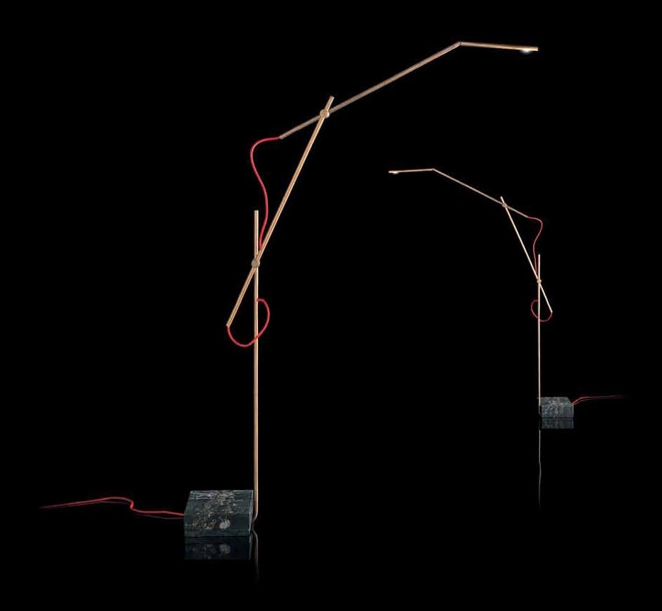 Pipe Light-L: Two L-shaped bronze lamps with a bulb at the end and red wiring on a black background.