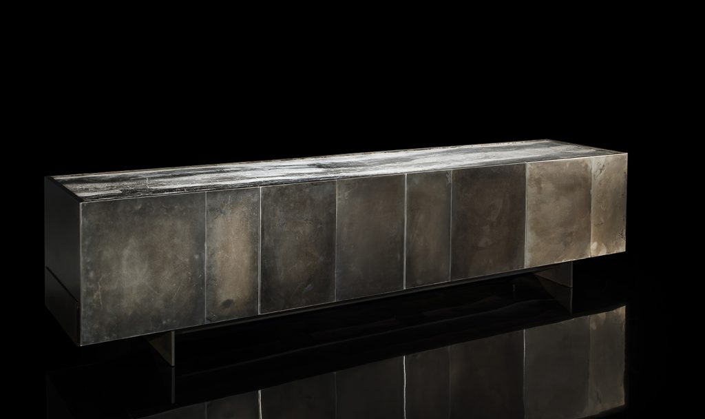 Side X Evo table, structure in natural wood covered with silver metal and top in brown and white marble pattern stone on a black background.