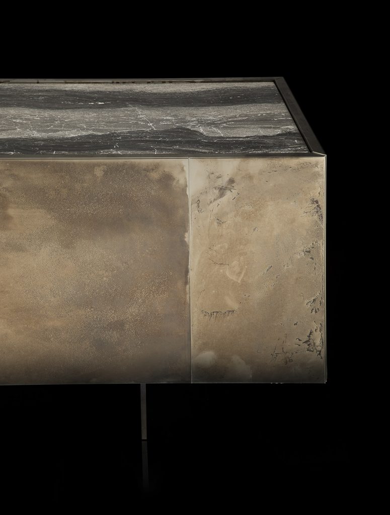 Side X Evo table, structure in natural wood covered with silver metal and top in brown, black and white marble pattern stone on a black background.
