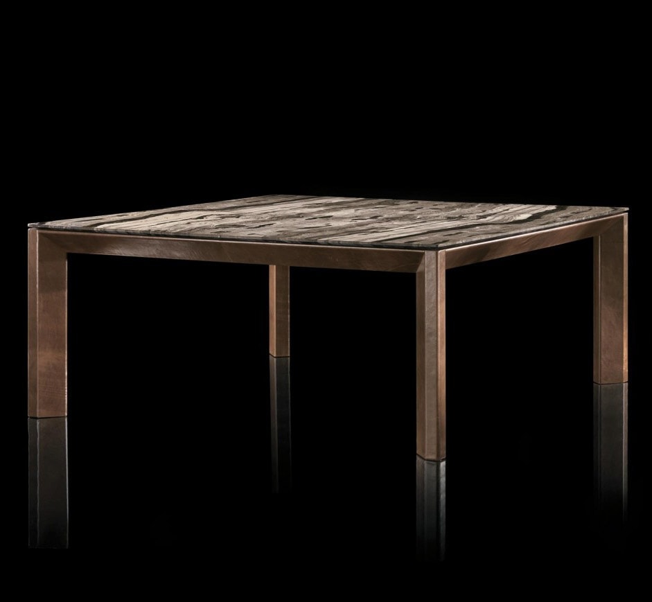 Soprano dining table, structure and four legs in brown wood, top in white, grey, brown and black stone on a black background.