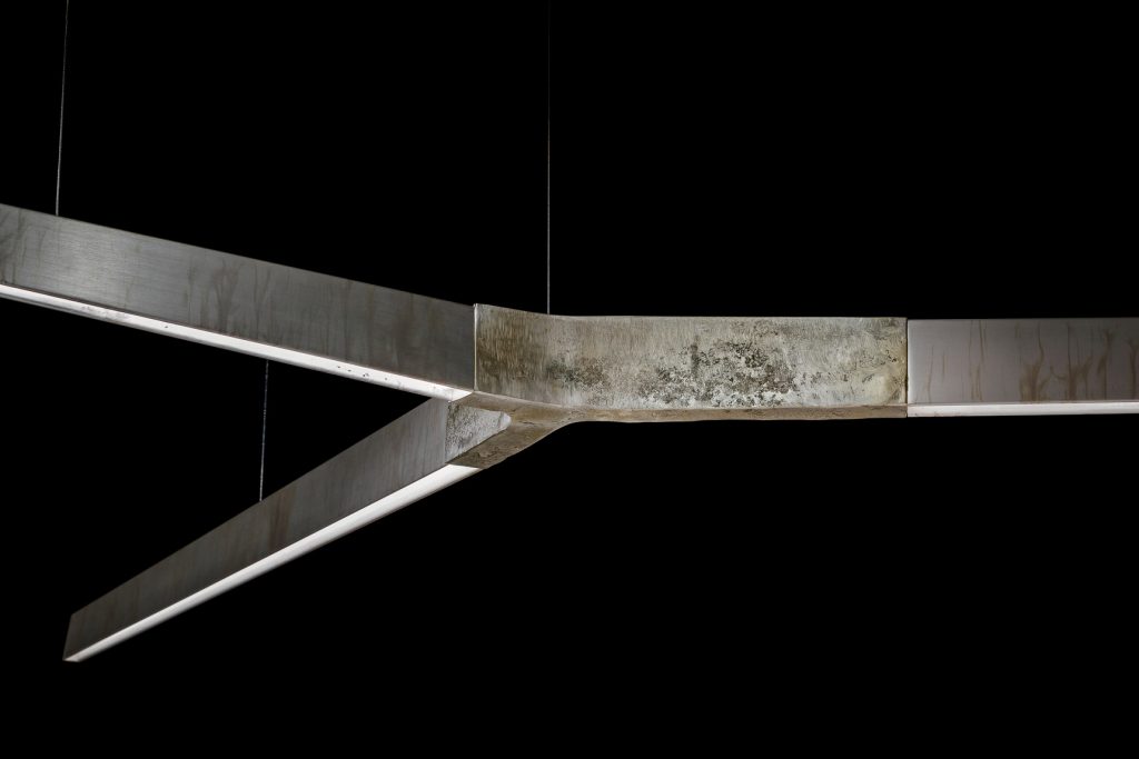 pendant lamp made of cast bronze with a design in geometric lines in a gray tone