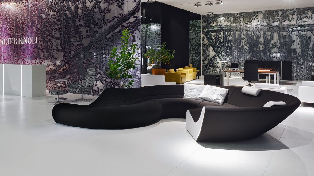 Circle sofa with curved shape upholstered in black and white in a living room.