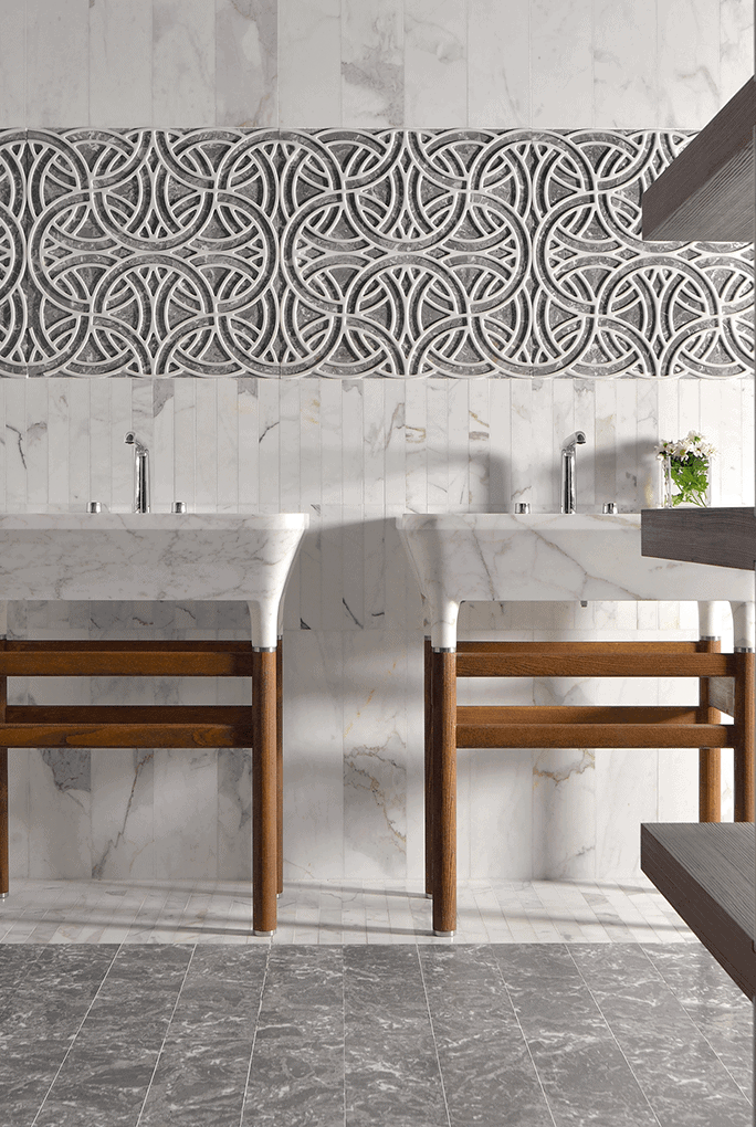 Rondo finish mosaic in bgray tones with circular patterns, in a bathroom.