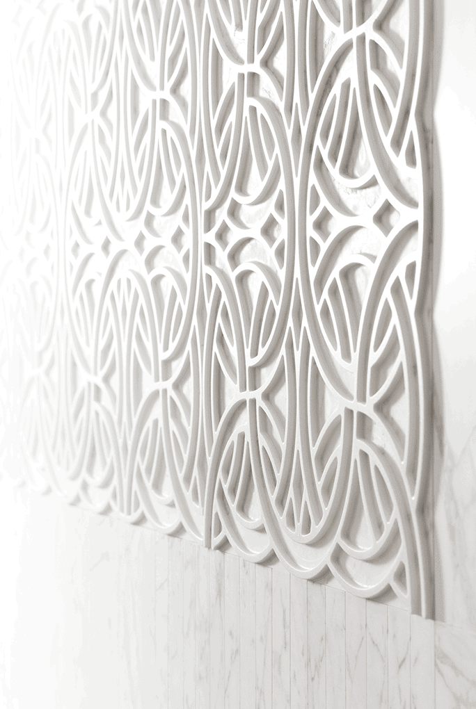 Rondo finish mosaic in white tones with circular patterns on a wall.