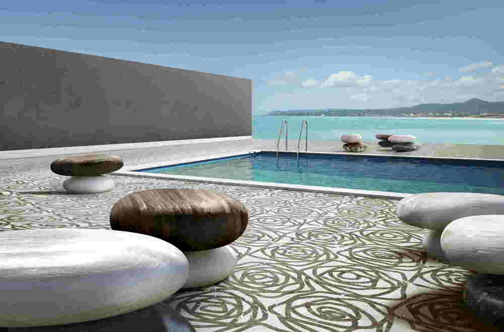 Rose finish marble sample in white and black color with rose patterns, on the floor of a pool space.