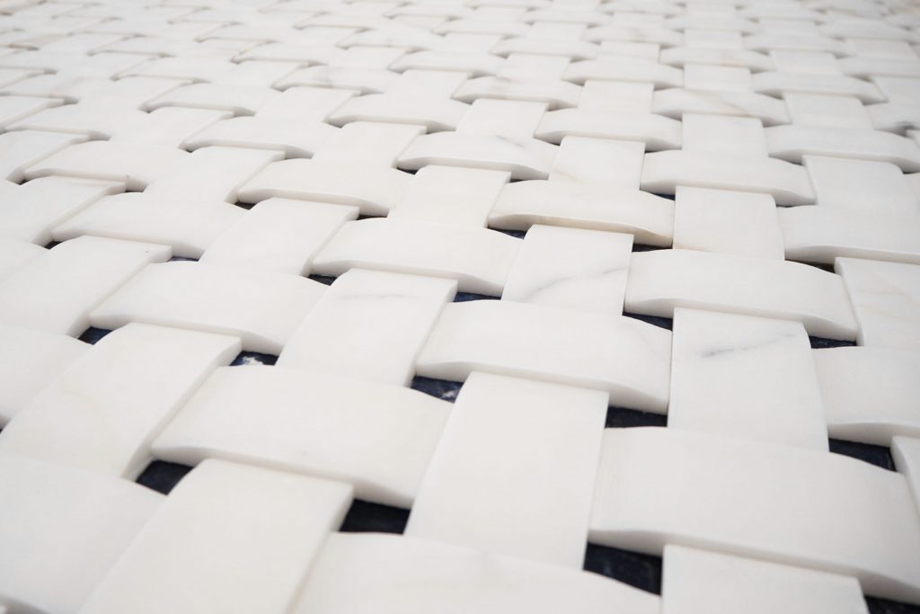 White Texo finish marble with woven patterns.