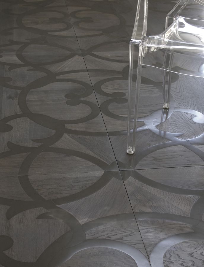 Inlay mosaics wood finish with black and gray flower like patterns.
