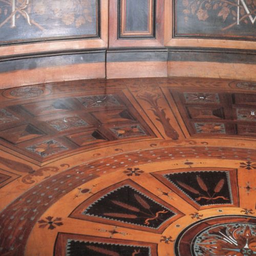 Marquetry finish in dark brown with intricate inlay patterns.