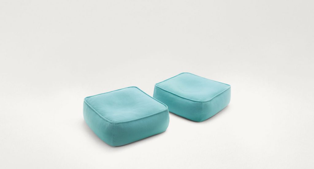 Two Float Outdoor Poufs, upholstery in blue fabrics on a white background.