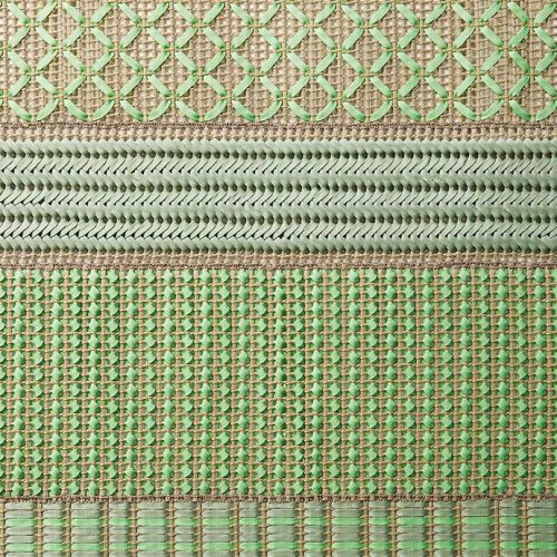 Grafismi modular rug. The geometric pattern is embroidered with green and brown flat braids in Rope yarn on kimia fabric.