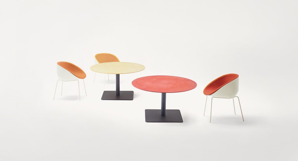 Three Amable Outdoor Chairs, four legs of white steel, white shell and rope cord cover, two in orange and one in red in a dining room.