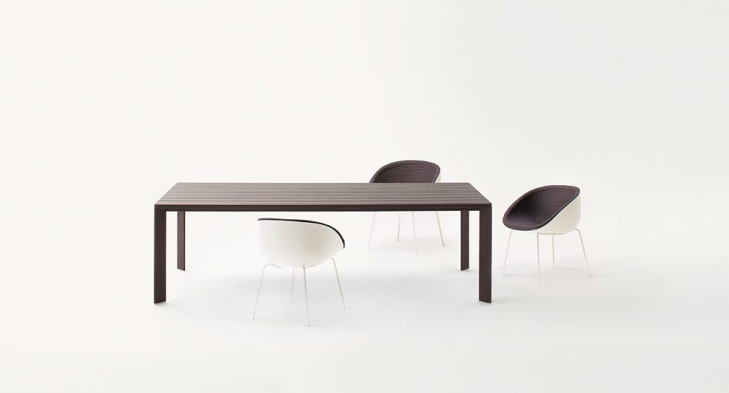 Three Amable Outdoor Chairs, four legs of white steel, white shell and brown rope cord cover in a dining room.