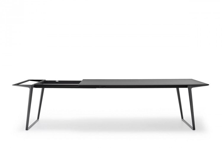 A Axy table extension, top and two legs in black aluminium in a dining room.