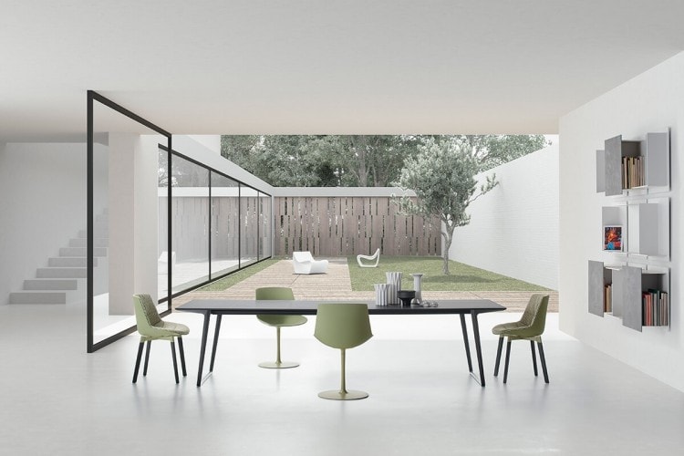 A Axy table, top and two legs in black aluminium in a dining room.