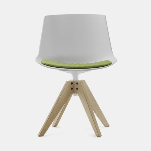 A white and green Flow Chair Padded with a natural wooden bottom on a white room background.