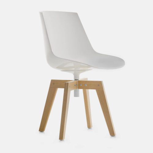 A white Flow Chair Iroko with four-legged in natural oak on a white room background.